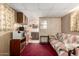 Finished basement with paneled walls, red carpet and view into the attached kitchen at 8632 E Delilah Ave, Mesa, AZ 85208