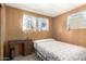 Bedroom with a simple desk and large window, complemented by wood paneling at 8632 E Delilah Ave, Mesa, AZ 85208