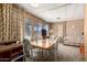 Bright dining area with classic wood paneling and large windows at 8632 E Delilah Ave, Mesa, AZ 85208