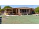 View of the home's front exterior with a screened-in porch and well-manicured yard at 8632 E Delilah Ave, Mesa, AZ 85208