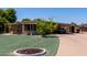 Charming home with lush green lawn, mature tree, and long driveway with carport at 8632 E Delilah Ave, Mesa, AZ 85208