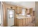 Traditional kitchen with wood cabinets and convenient exterior access at 8632 E Delilah Ave, Mesa, AZ 85208