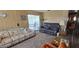 Cozy living room features a comfortable sofa, recliner, and access to a sunroom at 8632 E Delilah Ave, Mesa, AZ 85208