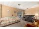 Comfortable living room featuring wood-paneled walls, cozy seating, and access to outdoor patio at 8632 E Delilah Ave, Mesa, AZ 85208