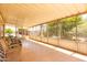 Well-lit sunroom with tile floor and ample room for multiple seating areas at 8632 E Delilah Ave, Mesa, AZ 85208