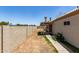 View of the backyard featuring mature trees, block wall, patio and covered space at 9002 W Caribbean Ln, Peoria, AZ 85381