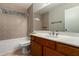 Well-maintained bathroom featuring tiled walls and floors, and a vanity at 9002 W Caribbean Ln, Peoria, AZ 85381