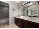 Bathroom with double sink vanity, tile floors and large framed mirror at 9002 W Caribbean Ln, Peoria, AZ 85381