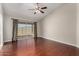 Bright bedroom with hardwood floors and sliding glass door to the backyard at 9002 W Caribbean Ln, Peoria, AZ 85381