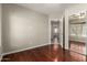Bedroom showcases laminate flooring, neutral walls, and a closet with mirrored doors at 9002 W Caribbean Ln, Peoria, AZ 85381