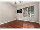 Cozy bedroom with a large window for natural light and warm wood-look laminate floors at 9002 W Caribbean Ln, Peoria, AZ 85381