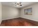 Empty bedroom with hardwood floors, ceiling fan, and natural light at 9002 W Caribbean Ln, Peoria, AZ 85381