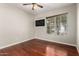 Inviting bedroom space with wood-look floors, a window, and neutral wall color at 9002 W Caribbean Ln, Peoria, AZ 85381