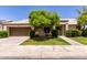 Charming single-story home with a well-manicured lawn, mature landscaping, and a two-car garage at 9002 W Caribbean Ln, Peoria, AZ 85381