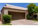 Charming single-story home with a well-manicured lawn, mature landscaping, and a two-car garage at 9002 W Caribbean Ln, Peoria, AZ 85381