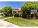 Charming single-story home with lush landscaping and mature trees enhancing its curb appeal at 9002 W Caribbean Ln, Peoria, AZ 85381