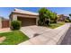 Charming single-story home with a well-manicured lawn, mature landscaping, and a two-car garage at 9002 W Caribbean Ln, Peoria, AZ 85381