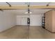 Spacious garage with epoxy flooring, ample storage, and a water heater at 9002 W Caribbean Ln, Peoria, AZ 85381