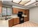 Well-maintained kitchen with wood cabinets and modern appliances at 9002 W Caribbean Ln, Peoria, AZ 85381
