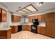 Bright kitchen featuring tile flooring, wood cabinetry, and a functional layout at 9002 W Caribbean Ln, Peoria, AZ 85381