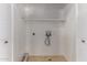 Dedicated laundry room with hookups, shelving, and tiled floors at 9002 W Caribbean Ln, Peoria, AZ 85381