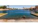 Water access featuring a serene canal with a goose in the foreground and waterfront homes in the background at 9002 W Caribbean Ln, Peoria, AZ 85381