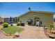 A backyard with an artificial turf lawn, a grill, and outdoor seating under a clear sky at 9822 E Main St # 4, Mesa, AZ 85207
