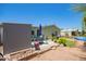 Backyard showcasing outdoor seating, a grill, and desert landscaping under a clear blue sky at 9822 E Main St # 4, Mesa, AZ 85207