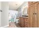 A bathroom with a shower with a cactus-themed shower curtain, a vanity, and a mirrored medicine cabinet at 9822 E Main St # 4, Mesa, AZ 85207