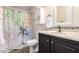 A bathroom featuring a toilet, sink, a colorful shower curtain, and a white cabinet at 9822 E Main St # 4, Mesa, AZ 85207