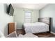 A bedroom with light-green walls, a window, and a bed with a floral comforter and wood-style headboard at 9822 E Main St # 4, Mesa, AZ 85207