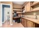 A home office with built-in shelving, a desk, and a view into another room at 9822 E Main St # 4, Mesa, AZ 85207
