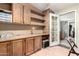 An office space with custom built-in cabinetry, shelves, desk area, and a separate entrance to another room at 9822 E Main St # 4, Mesa, AZ 85207