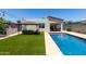 Backyard pool and outdoor seating area with modern gazebo and artificial grass at 1005 E Weldon Ave, Phoenix, AZ 85014