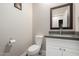 Elegant powder room with modern fixtures and a decorative mirror at 1005 E Weldon Ave, Phoenix, AZ 85014
