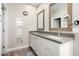 The bathroom offers dual sinks with a mirror, vanity, and a glass-enclosed shower for a spa-like feel at 1005 E Weldon Ave, Phoenix, AZ 85014