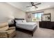 This bedroom features a ceiling fan, dresser, and comfortable furniture for a relaxing retreat at 1005 E Weldon Ave, Phoenix, AZ 85014