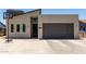 Modern home featuring a contemporary design, gray garage door, and a basketball hoop in the driveway at 1005 E Weldon Ave, Phoenix, AZ 85014