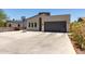 Street view of modern home featuring a contemporary design, gray garage door, and a basketball hoop in the driveway at 1005 E Weldon Ave, Phoenix, AZ 85014