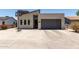 Modern home featuring a contemporary design, gray garage door, and a basketball hoop in the driveway at 1005 E Weldon Ave, Phoenix, AZ 85014