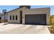 Modern home featuring a contemporary design, gray garage door, and a basketball hoop in the driveway at 1005 E Weldon Ave, Phoenix, AZ 85014