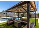 A view of the gazebo with outdoor seating and a view of the pool and grass at 1005 E Weldon Ave, Phoenix, AZ 85014