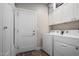 Laundry room featuring a washer, dryer, overhead cabinets, and a closet at 1005 E Weldon Ave, Phoenix, AZ 85014