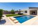 Backyard pool and outdoor seating area with modern gazebo and artificial grass at 1005 E Weldon Ave, Phoenix, AZ 85014