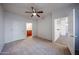 Bedroom featuring neutral carpet, a ceiling fan, and two doorways adds comfort and functional versatility at 11375 E Sahuaro Dr # 1053, Scottsdale, AZ 85259