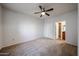 Bedroom boasts neutral carpet, a ceiling fan, and an ensuite bathroom for added comfort and convenience at 11375 E Sahuaro Dr # 1053, Scottsdale, AZ 85259