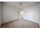 Bright carpeted bedroom with ceiling fan and two entry doors creates versatile access and a spacious feel at 11375 E Sahuaro Dr # 1053, Scottsdale, AZ 85259