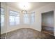 Charming dining room area with tiled floor, three large windows and a modern chandelier at 11375 E Sahuaro Dr # 1053, Scottsdale, AZ 85259