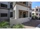Exterior view of a condo with a covered porch, nice desert landscaping and an outdoor staircase for upper units at 11375 E Sahuaro Dr # 1053, Scottsdale, AZ 85259