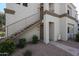 Exterior view of building with outdoor stairs, and two units, showing landscaping and neutral color scheme at 11375 E Sahuaro Dr # 1053, Scottsdale, AZ 85259
